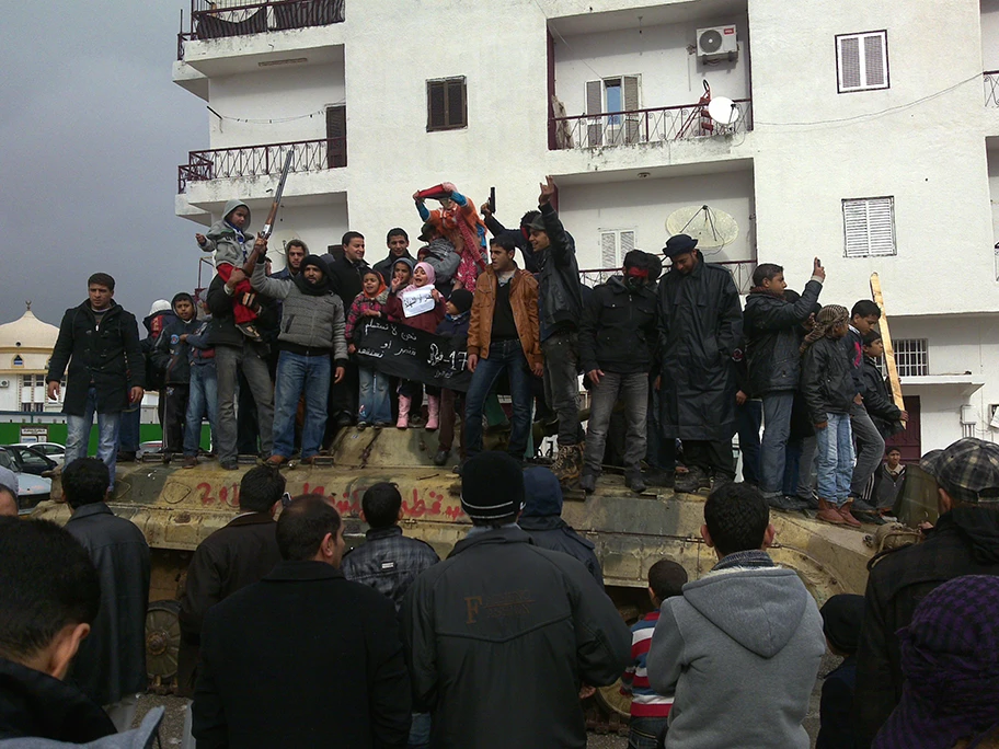 Siegesfeier von libyschen Rebellen auf einem zerstörten Panzer eines Gaddafi-Bataillons in Al Bayda, Libyen.