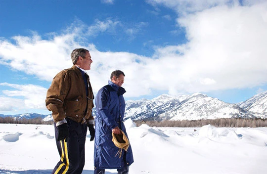 George W. Bush and friend Roland Betts walk a private trail along the Snake River in Jackson Hole.