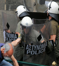 Old_man_hit_by_Riot_Police_in_demonstrations_in_Athens_Greece_2.jpg