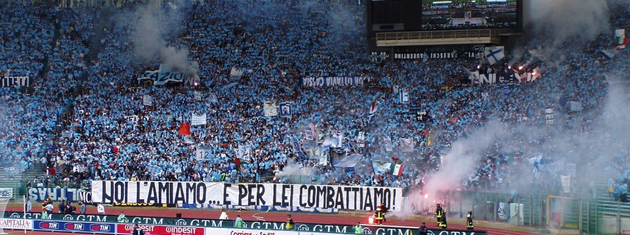 Fankurve des Lazio Rom bei einem Heimspiel. Die Ultragruppierung «Irriducibili Lazio» ist bekannt dafür, dass sie sich offen zum Faschismus bekennt. Lazio wurde vom italienischen Verband deswegen schon mehrfach mit Platzsperren oder Spielen unter Ausschluss der Öffentlichkeit bestraft.