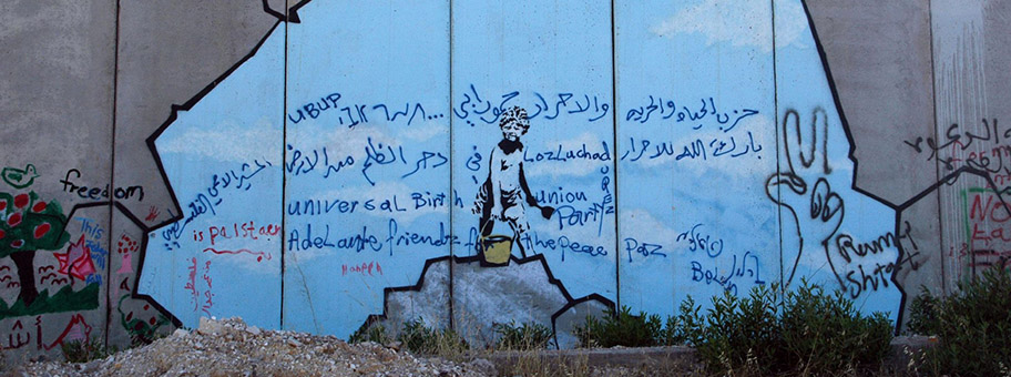 Banksy-Graffiti an der Grenzmauer in der West Bank bei Kalandia.