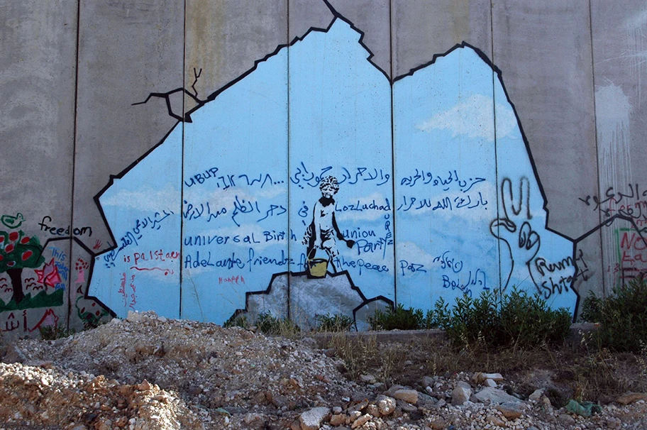 Banksy-Graffiti an der Grenzmauer in der West Bank bei Kalandia.